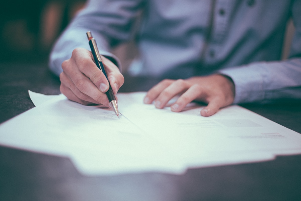 Legal documents and a pen arranged for review on a desk
