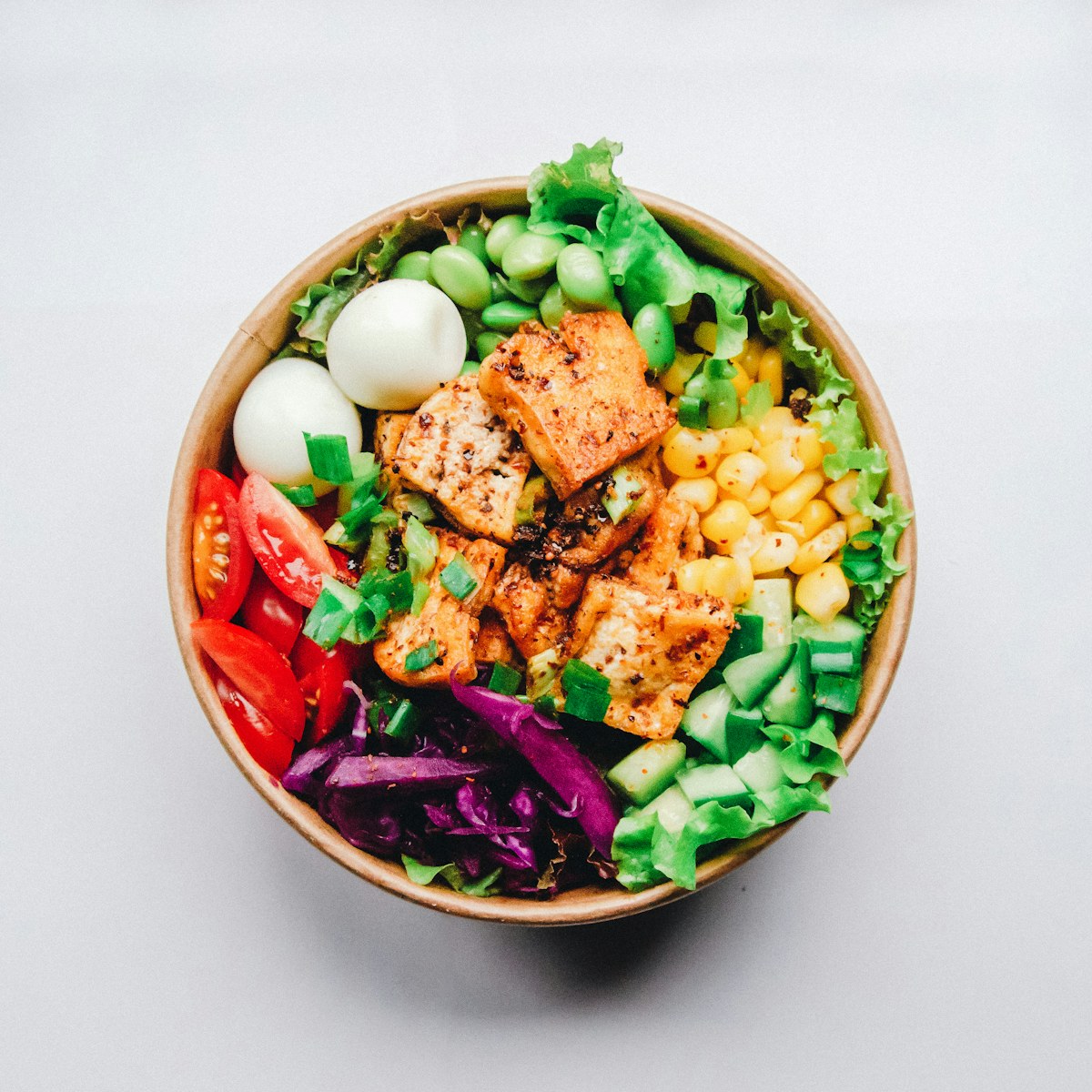 Colorful green salad bowl with herbs and vegetables